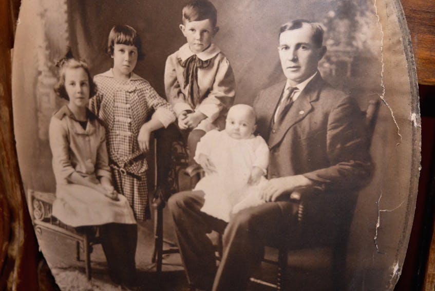 This portrait of a man and four children was found in the attic of a century-old north end Sydney house. However, the homeowner has no idea who they were and is hoping someone might be able to help him identify the subject of the old picture.