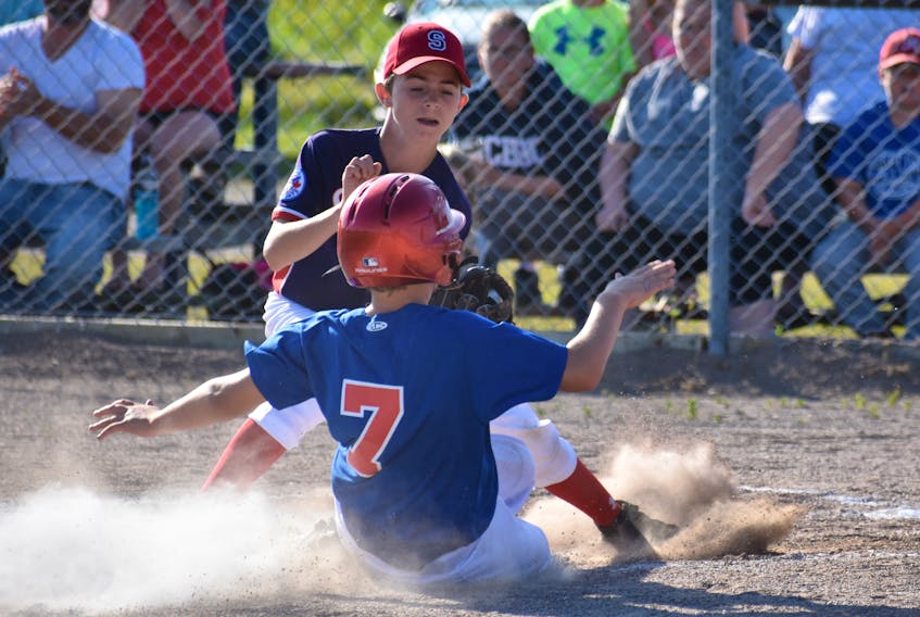 Second baseman Thomas Jessome (7) of the Sydney Mines Ramblers is tagged out at home plate by pitcher Cole Murphy of the Sydney Sooners during play at the Nova Scotia Major Little League championships on Monday at Joe Scott Memorial Ball Field in Sydney Mines. Sydney won the game 16-2. Play continues all week with round-robin games slated for 5:30 p.m. each night.