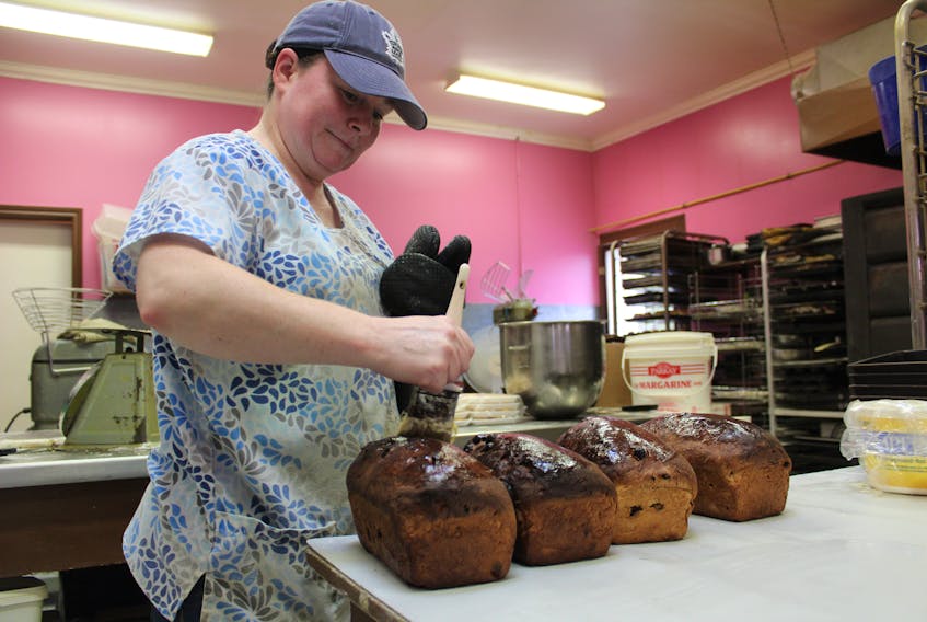 Kelly Nicholson puts the finishing touches on several loaves of freshly baked raisin bread at Gloria’s Goodies in North Sydney. The bread was popular with the bakery’s customers on Monday as were the other freshly baked goods in the store.