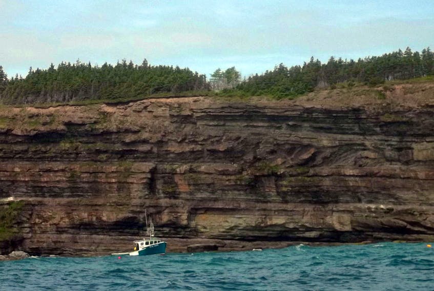 The size of the fishing boat at the base of the cliffs at South Head offers some perspective as to the height of the cliff. Directly across the water from Port Morien, Morien Bay is bounded by a rocky headland. The craggy cliffs of Cape Morien, some 15 metres in height, adjoin a rugged shoreline that stretches some nine kilometers along the bay to the Homeville River. Once called South Port Morien, the area is now called South Head.