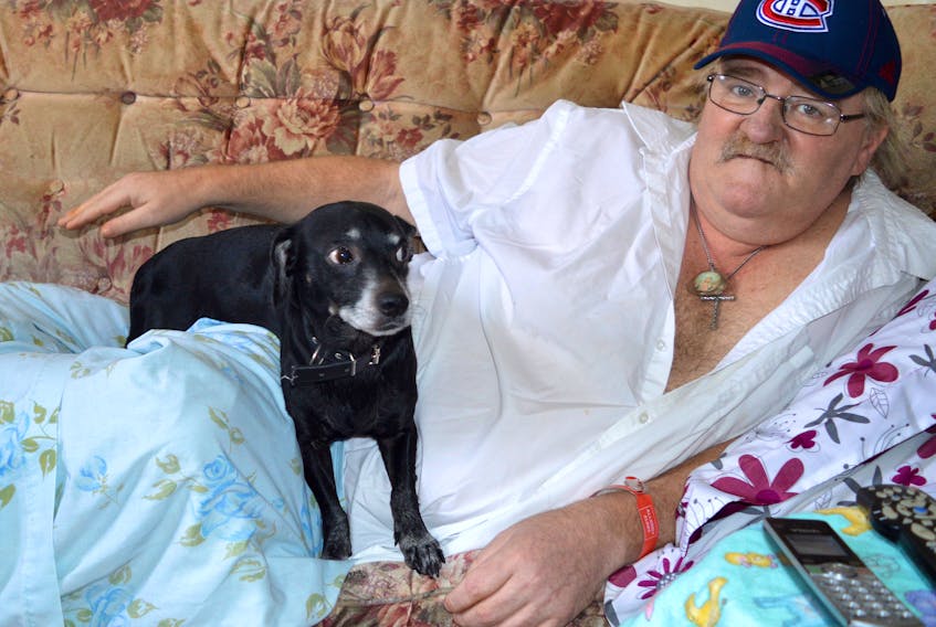 Bobby Donovan, treasurer of the Glace Bay Y’s Men’s and Women’s Club, rests at his apartment on King Edward Street with his dog Fluke. Although Donovan has been battling prostate cancer for two years, it hasn’t slowed him down in his passionate work for the community.