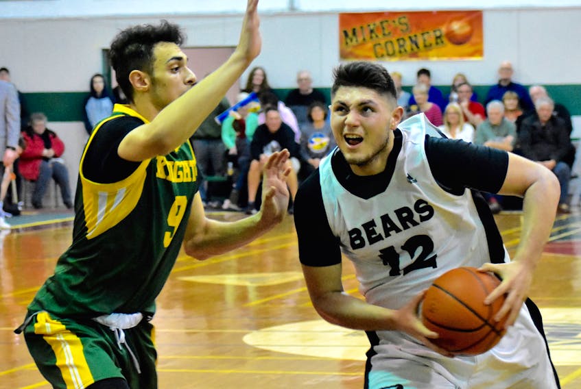 Dylan Messervey, right, of the Breton Education Centre Bears drives the lane as Majd Daqqa of Holy Trinity Northern Knights looks on during New Waterford Coal Bowl Classic semifinal action at the Breton Education Centre gym, Friday. The Northern Knights won the game 96-80.