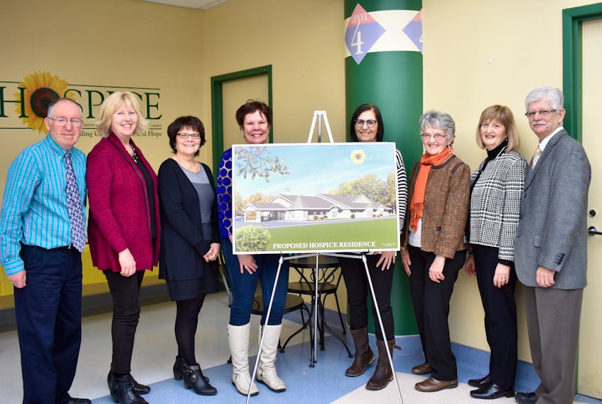 Board and staff members of the Hospice Palliative Care Society of Cape Breton County at the 10th anniversary reception held outside the An Cala palliative care unit on Monday show off the proposed hospice residence that they hope will eventually become a reality. Shown, from left, Lorne MacDougall, Pam Ellsworth, Kathy Forsey, Michelle McKinnon, Nancy Dingwall, Dale Orychock, Irene Khatter and Aurelle Landry.