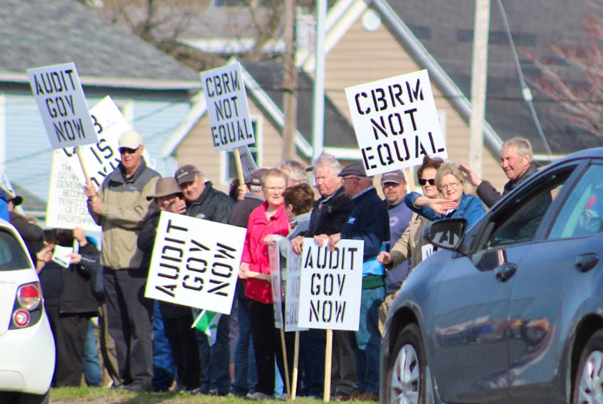 These protesters, shown here waving at vehicles on Prince Street, were among an estimated 600 people who turned out for a Wednesday afternoon rally in front of Sydney’s provincial building. The rally, organized by Nova Scotians for Equalization Fairness, was held to send a message to the provincial government that Cape Breton wants its fair share of the $1.8-billion federal equalization transfer payment that Nova Scotia receives each year.
