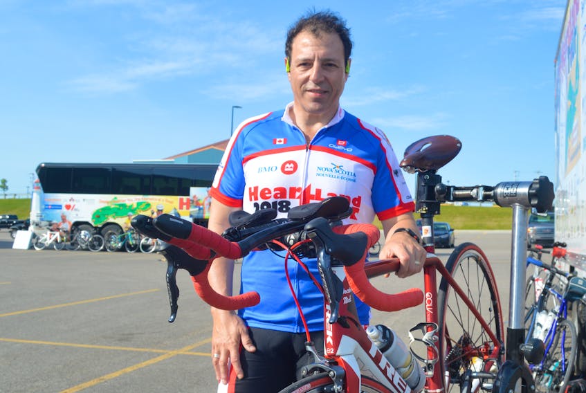 Dr. Nicholas Giacomantoni stands beside his bicycle prior to the start of Monday’s Heartland Tour.