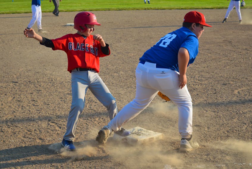 Breton Parsons of the Glace Bay McDonald’s Colonels, left, arrives safely at third base ahead of the throw to Connor Lavoratore of the Sydney Mines Ramblers at the 2018 Nova Scotia Major Little League Championship tournament Monday at Vince Muise Field. The Colonels won the game 12-0 in five innings.