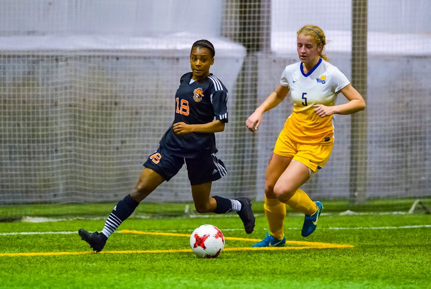 Cape Breton’s Tamara Brown, left, stays a step ahead of Victoria’s Katie Carrothers during the Capers’ 2-1 win over the Vikes at in the quarter-finals of the national university women’s soccer championships in Winnipeg, Man. JEFF MILLER/Usport