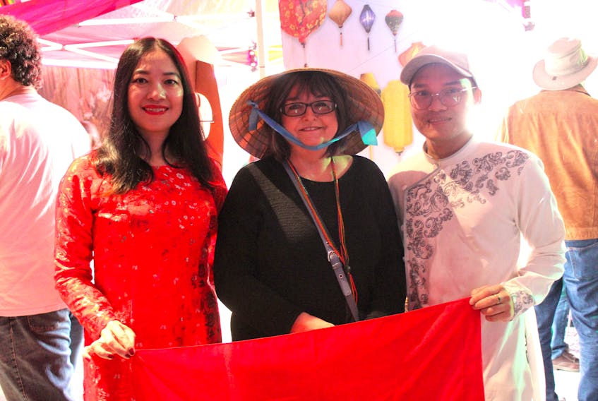 Downtown Sydney was alive with energy as cultures from around the world were on display at the Hello Cape Breton festival held Saturday at the Joan Harriss Cruise Pavilion. Doreen MacKinlay of Sydney, centre, posed for a photograph wearing a traditional Vietnamese hat loaned to her by Jessica Huynh a master of business administration student from Vietnam and, Brian Ho, a bachelor of business administration student also from Vietnam.