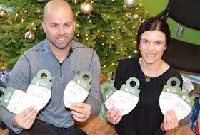 Brian Howley and his wife Melissa McDonough, owners of Cabot Physiotherapy in Sydney and Glace Bay, hold up some of the bulbs with names of lonely or low-income seniors and suggestions of something for them for Christmas, hanging on their tree at their Sydney location, as part of the annual ‘Be a Santa to a Senior’ program being coordinated by Home Instead Senior Care. There is a tree also set up at their Glace Bay location, as well as other stores in Sydney and North Sydney. The idea of the program is bringing some Christmas cheer to a lonely or low-income senior.