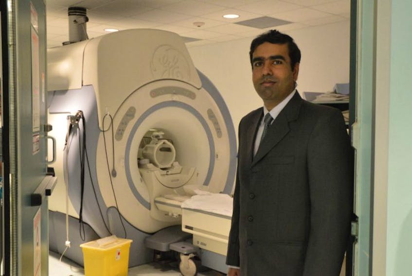 Dr. Syed Zafar Ali stands beside the current MRI unit at the Regional Hospital. 