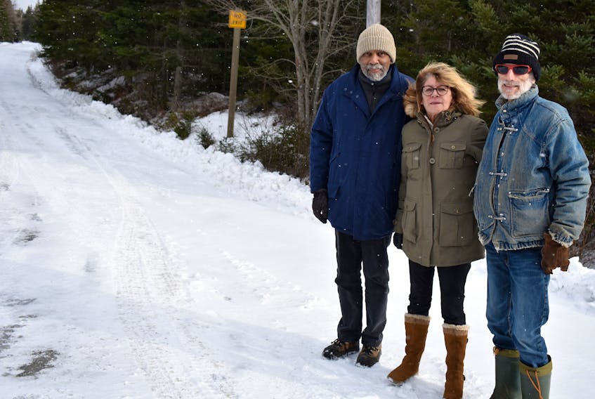 Gene Kersey, from left, Heather Hayes and Tim Menk, all directors of Friends of Gabarus Society, stand at the start of Oceanview Road. The road ends at the Louisbourg-Gabarus road, which closed in the mid-1960s. It is part of the Fleur-de-Lis Trail and the Friends of Gabarus Society is starting a campaign to get the road reopened.