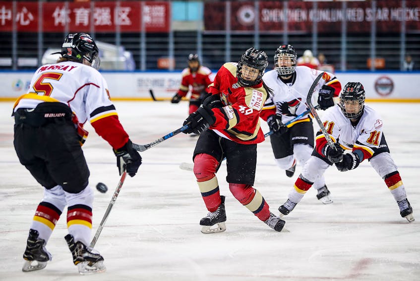 Baddeck’s Jessica Wong, middle, fires the puck in a game against the Calgary Inferno during the 2017-18 season. Wong came out of retirement to play for the Kunlun Red Star, one of two expansion teams from China in the Canadian Women’s Hockey League.