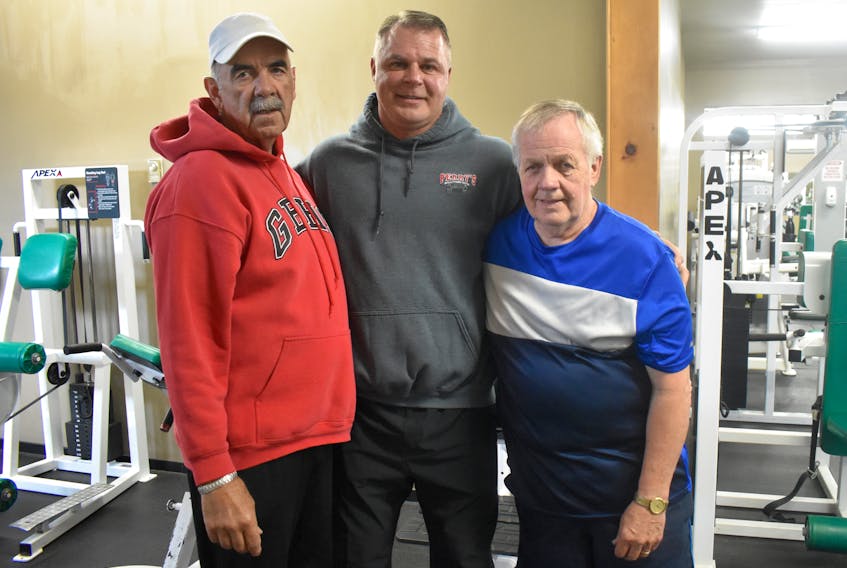 Perry’s Gym owner Perry Moore, centre, stands with Dave Clarke, left, and Ron Cote. Clarke and Cote, who both have mobility issues due to medical conditions, have been going to the gym for a year and a half. They credit Moore, his staff and his training programs with improving their overall well-being and mobility.