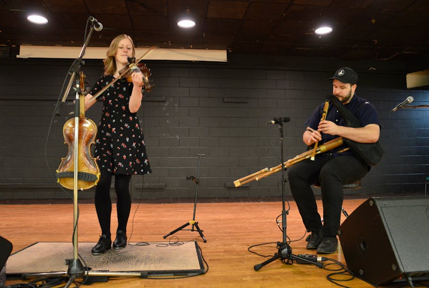 Anita MacDonald, left, and Ben Miller of Miller/MacDonald/Cormier get ready to perform in front of students at Breton Education Centre in New Waterford on Wednesday as part of the Celtic Colours in the Schools program. The two, along with guitarist Zakk Cormier will be performing throughout the nine-day festival as well.