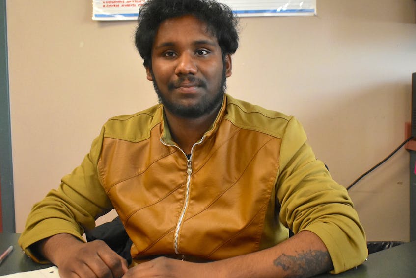 Samual Shaji sits at his desk at the multicultural hub at Cape Breton University. The international student from India recently lost an envelope filled with cash that was returned to him by Sydney resident Ross Covey.