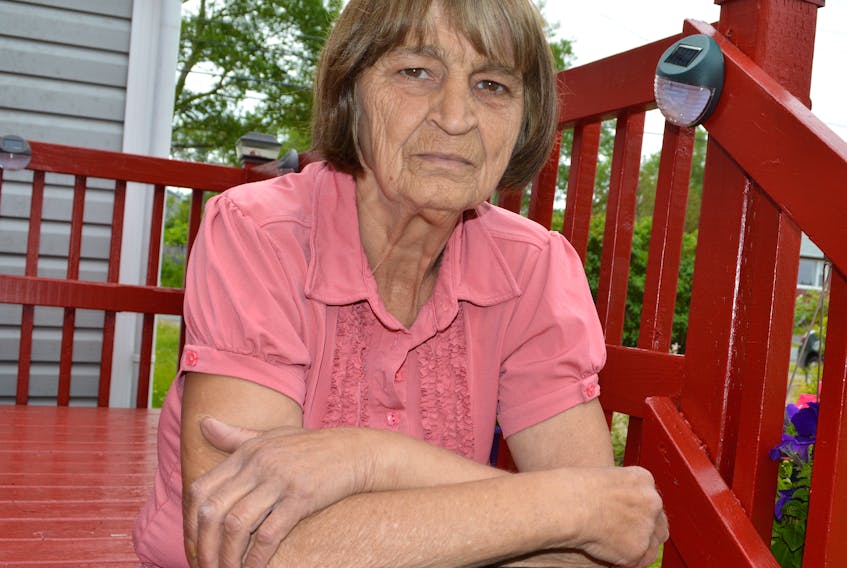 Brenda Dunlop sits on the deck of her home in Glace Bay as she mourns her brother Shawn Yorke, who was murdered in his home in Kitchener, Ont., on July 8. Waterloo Regional Police say Shawn died from a gunshot wound and believe he was targeted.
