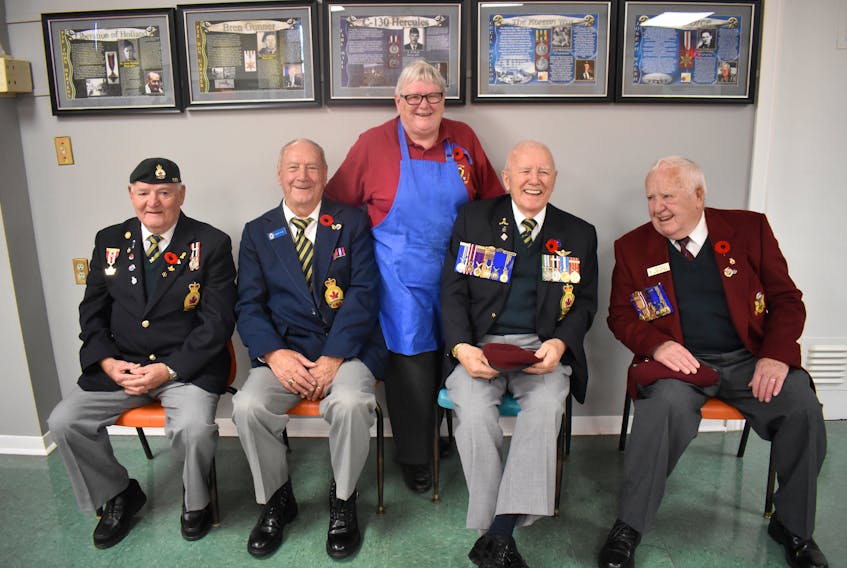 Alaine Taylor, centre, is flanked by North Sydney legion members Joe Hillier, Robert Ryan, Hec Lewis and Eric MacLean after Taylor and her team of volunteers served up dozens of breakfasts to veterans, firefighters and their friends and families prior to Monday’s Remembrance Day service in North Sydney.