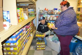 Michael MacNeil, left, a volunteer with the Glace Bay Food Bank, puts away some canned milk assisted by Michelle Kalbhenn, coordinator of the food bank. More than $4,255 was recently raised by Mickey’s Original Six either in milk or donations to purchase milk. Kalbhenn said they are appreciative as without this donation milk for clients would be limited. The annual fundraiser began seven years ago after Mickey McNeil, founder of Mickey’s Original Six, read a story in the Cape Breton Post where the food bank was appealing for donations of milk as some families were unable to afford it and were forced to put water on their cereal.