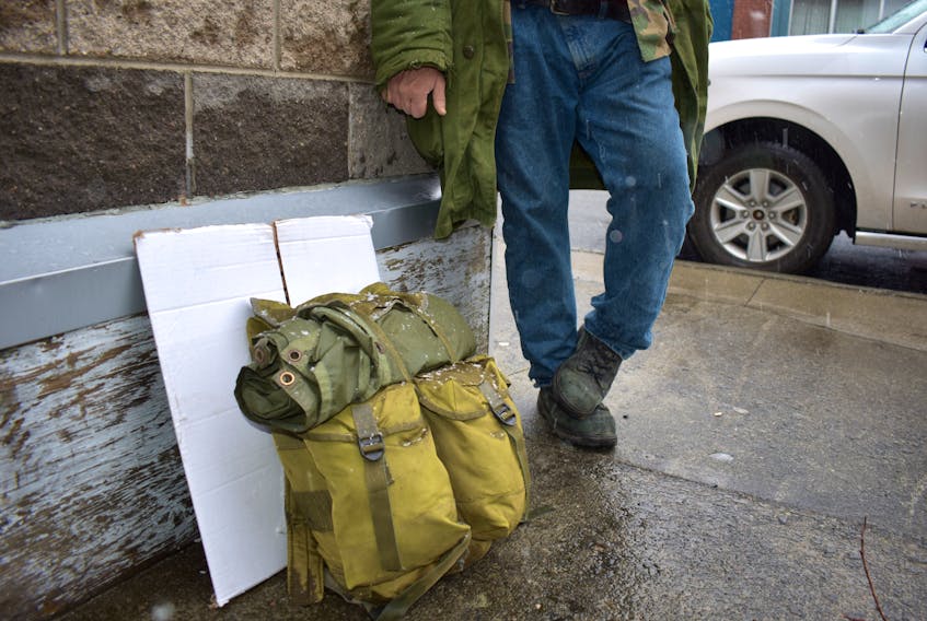 Keith, a 50-year-old homeless man who’s been staying at a Sydney shelter, stands on the sidewalk outside the Ally Centre of Cape Breton in early December, 2019. Keith, who didn’t want his last name used or face shown, said people who use the Community Homeless Shelter on Townsend Street now have their belongings searched by staff.