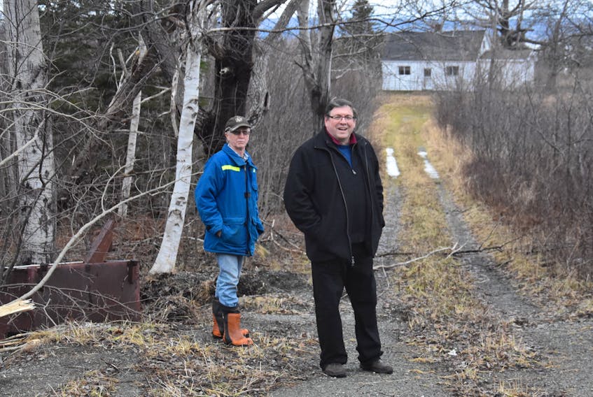 Big Pond Centre residents Roy MacInnis, left, and Mike Britten, stand at the driveway they believe would be the main entrance of an RV park and campground proposed for the area. Both men oppose the development, arguing that it will destroy their rural way of life and threaten the area’s sensitive ecosystem.