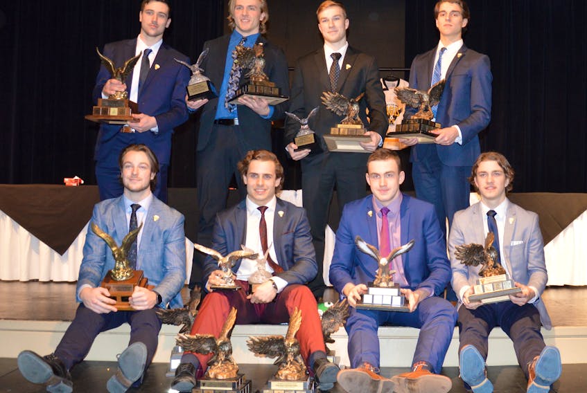 The winners at the Cape Breton Screaming Eagles team banquet pose with their trophies at the Membertou trade and Convention Centre on Monday. Front row, from left, are Tyler Hylland, Phélix Martineau, Egor Sokolov and Brooklyn Kalmikov. In back, from left, are Declan Smith, Ty Fournier, Ross MacDougall and Adam McCormick.