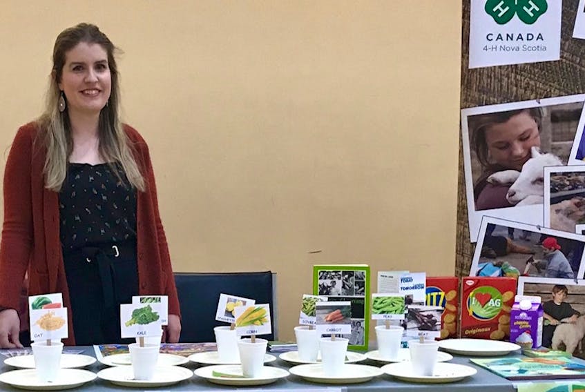 Nicole MacEachern, the summer assistant with the Nova Scotia Department of Agriculture, prepares to teach the children at YMCA Health Kids Day about seeds and butter.