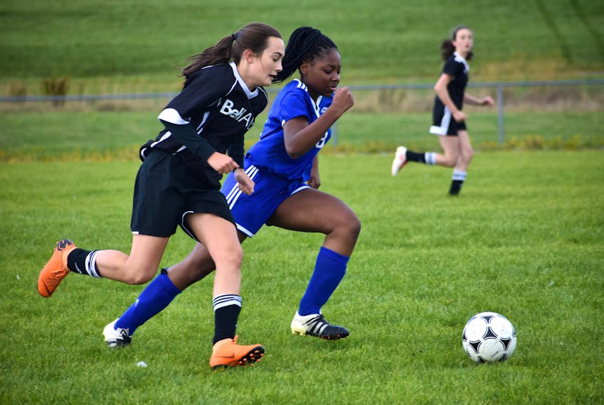 Emily MacLeod of the Glace Bay Panthers, left, and Clover Mulo of the Sydney Academy Wildcats chase after the ball during Cape Breton High School Soccer League play Thursday at Recreation Park in Glace Bay. Sydney Academy won the game, 5-0. The league opened the 2019 season on Wednesday.