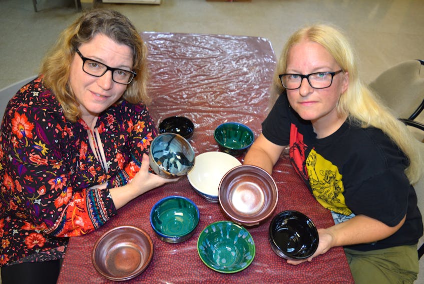 Elizabeth Burtt-Ivey, left, a potter, and Kimberly McPherson, garden co-ordinator at the Glace Bay Food Bank and also a potter, show some of the bowls they made for the Empty Bowl fundraiser to be held at the Glace Bay fire hall on Oct. 20 to raise moneys for the food bank. Last year’s event sold out immediately.