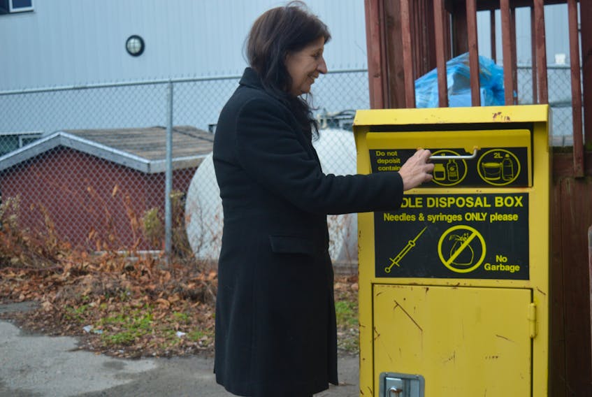 Christine Porter, executive director of the Ally Centre of Cape Breton, opens the safe needle drop off kiosk located outside their office on Bentinck Street in Sydney. The kiosks are a harm reduction strategy that helps reduce amount of improperly discarded used needles. Nikki Sullivan/Cape Breton Post