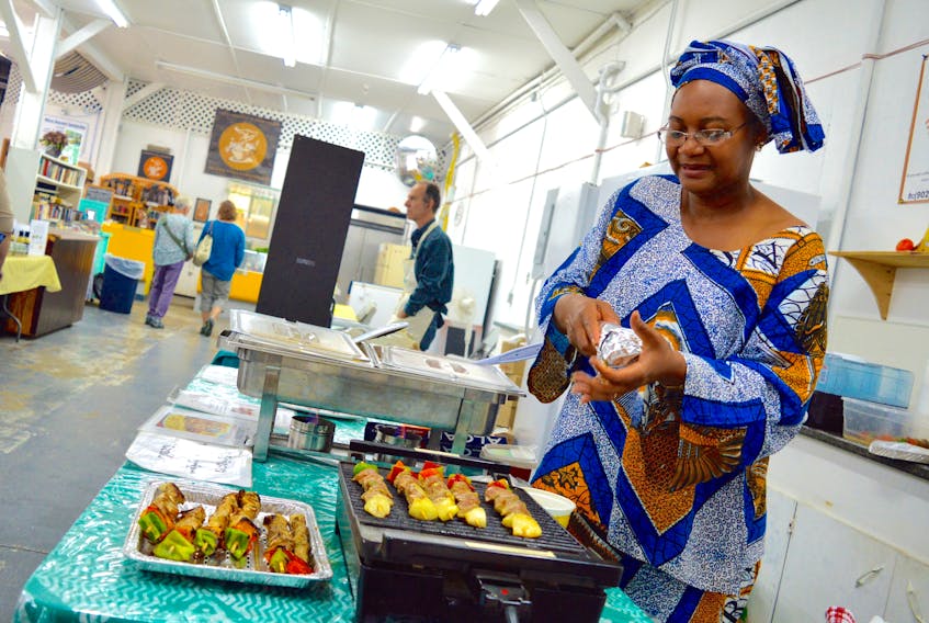 Gorelle Tsojo prepares chicken kabobs for customers at the Cape Breton Farmers' Market in this 2016 file photo. The Sydney-area market is in the process of re-opening in the former Smooth Herman’s Warehouse space on Falmouth Street. Farmers’ Markets of Nova Scotia Co-operative is now organizing a full-day conference in Baddeck on April 14 that is tailored to the needs of farmers’ market users.