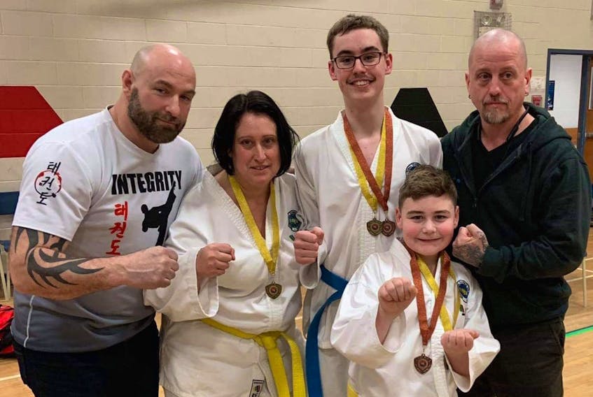 Members of Integrity Martial Arts competed in the ITF Open Taekwon-Do Championships held in Sackville, N.S., on March 14. Michelle Vaughan captured the gold medal in sparring and silver in patterns, while Conner Kennedy won gold in sparring and bronze in patterns. Jacob Hawco won the gold medal in sparring and bronze in patterns. From left are Jimmy Hall (head coach), Vaughan, Kennedy, Hawco, and Derek Sampson (main patterns coach). PHOTO SUBMITTED/JIMMY HALL
