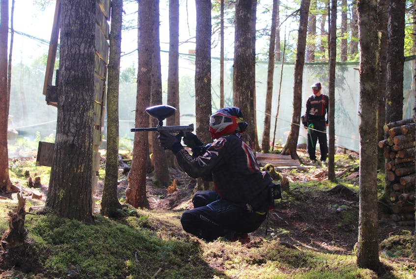 Tyler MacPhee, owner of Cape Breton County Paintball, prepares to take a shot during a round on Sunday.
