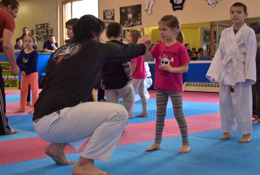 Erika MacDonald, 6, practises a self-defense move during the Bullying Stops Here workshop on Sunday. The free workshop took place at Whitall’s Martial Arts in Sydney.