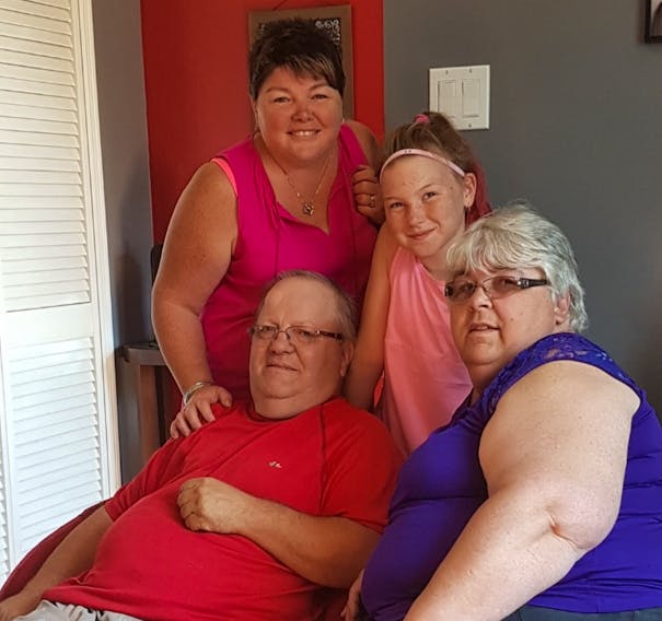 Theresa MacDonald, back left, of Port Hawkesbury, with daughter Teagen MacDonald, and parents William Ings and Elsie Ings, of Twillingate, N.L., during a visit last summer. MacDonald said her father was put in palliative care at home in Newfoundland last week and she’s desperately trying to find a way to visit him so she can say goodbye.