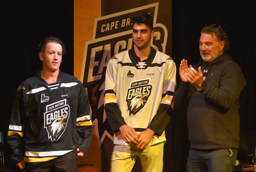 Cape Breton’s Quebec Major Junior Hockey League team announced a rebrand on Wednesday that featured a new logo. The team has also dropped the word “screaming” from its name and will now be known as the Cape Breton Eagles. Cape Breton players Derek Gentile, from left, and Kevin Mandolese are shown wearing the club’s new jerseys with majority owner Irwin Simon.