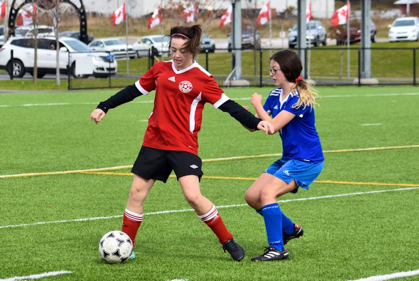 Riverview's Ashley Ross, left, protects the ball from Sydney Academy defender Maggie Campbell during Cape Breton High School Soccer League action on Monday at Open Hearth Park pitch in Sydney. Riverview was leading their longtime rivals in the Junior Varsity Division by a couple of goals at press time. Riverview JV carried a 6-1-1 record into the match, while the Sydney Academy JV Girls were 4-4-0. While the Coxheath-based squad was more dominant, coaches and parents agreed that both teams continue to improve with each game.
