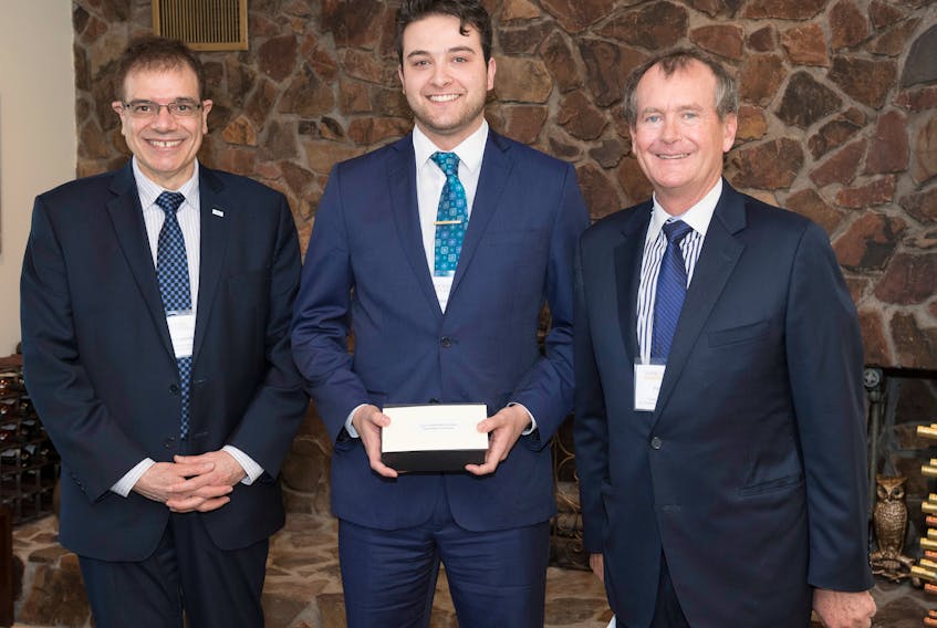 Roy Karam, centre, a fourth-year bachelor of business administration student at Cape Breton University, holds the Frank H. Sobey Awards for Excellence in Business Studies alongside Shannon School of Business dean George Karaphillis, left, and former Empire president and chief executive officer Paul Sobey.