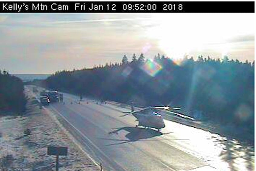 This Nova Scotia highway camera image shows a LifeFlight helicopter at the scene of the Jan. 12 Kellys Mountain crash involving a school bus and parked trailer. The bus driver was airlifted to Halifax with serious injuries.
