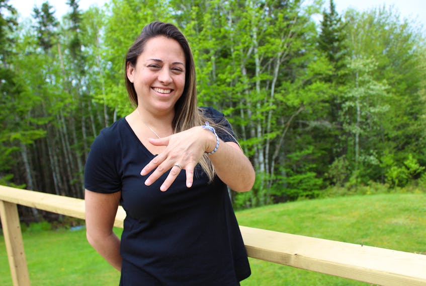 Perla MacLeod shows off her engagement ring at her home in Big Baddeck. The ring was stolen from MacLeod’s vehicle, along with her purse, roughly seven years ago. Both items were recently found on the side of the road during a spring cleanup.