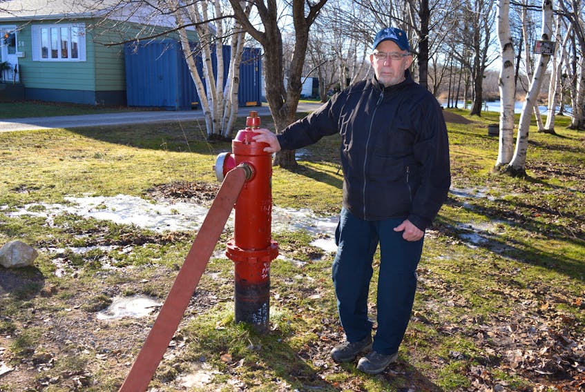 Allen LeForte stands near a hydrant beside a house he owns on Norwood Street in Glace Bay. LeForte said he has had issues with dirty water and the Cape Breton Regional Municipality flooding his land while trying to correct the problem for two-and-a-half years. Sharon Montgomery-Dupe/Cape Breton Post