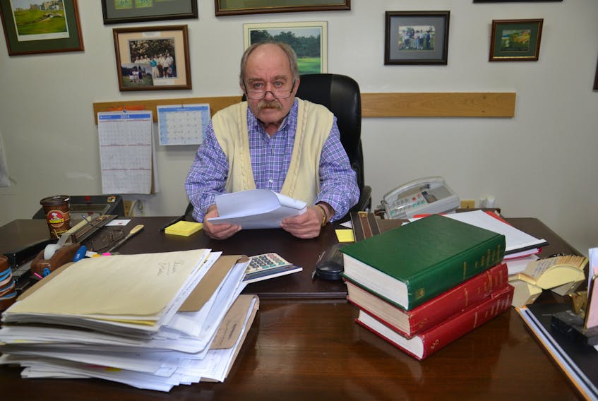 Defense lawyer Bill Burchell sits at his desk in his Sydney Mines office in this file photo. Burchell said he said he doesn’t think the new proposed changes to the impaired driving laws will affect his job much, but he does find the proposal to have mandatory alcohol screening “offensive.” CAPE BRETON POST PHOTO