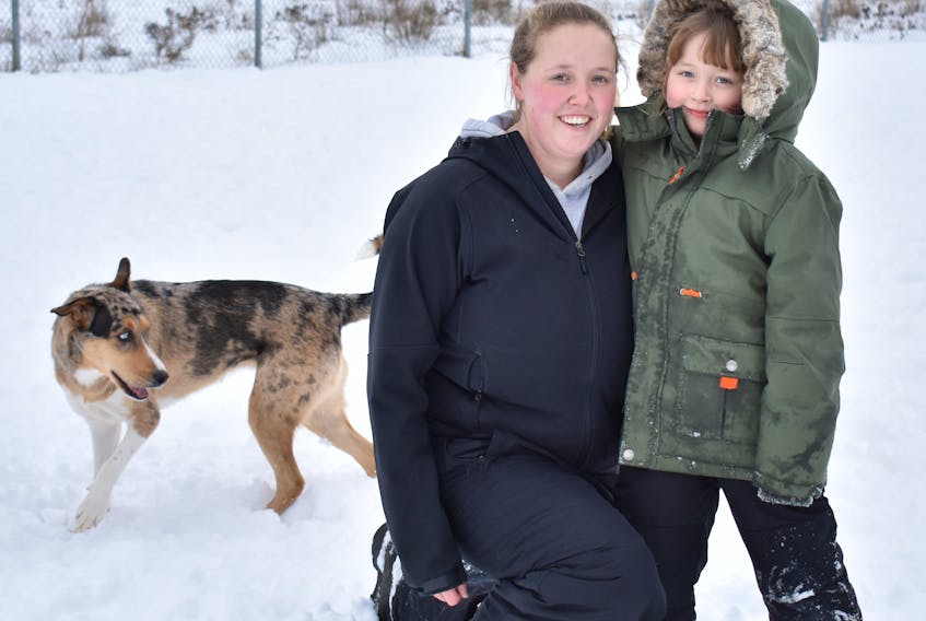 Tamara Martin, left, and her daughter Hannah Martin spent their afternoon snow day on Tuesday at the dog park at Open Hearth Park with their dogs Harley, left, and Luca (not shown).