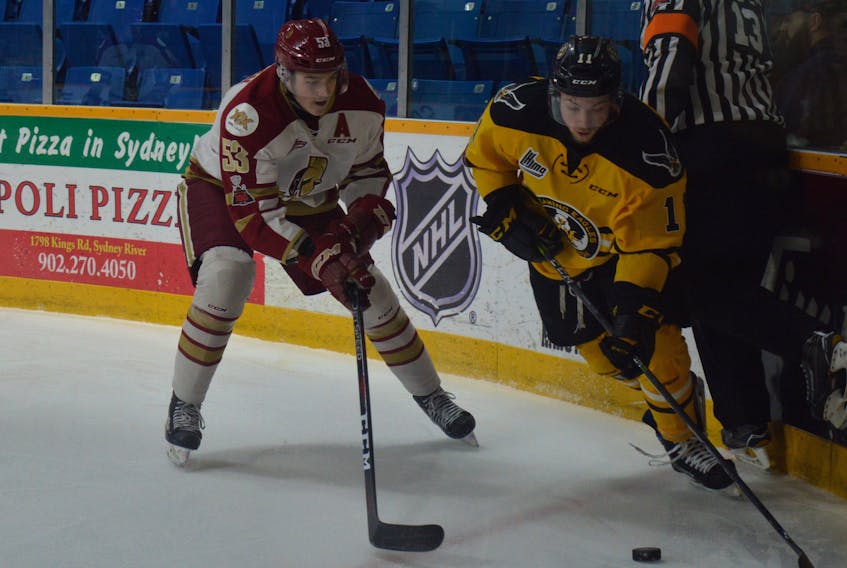Tyler Hylland, right, of the Cape Breton Screaming Eagles carries the puck in the offensive zone as Noah Dobson of the Acadie-Bathurst Titan pressures during Quebec Major Junior Hockey League action at Centre 200 on Friday. Hylland scored the overtime winner to give the Screaming Eagles a 2-1 win.