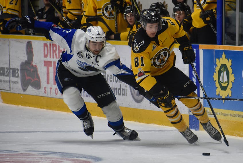 Mathias Laferrière, right, of the Cape Breton Screaming Eagles works his way around Bailey Webster of the Saint John Sea Dogs during Quebec Major Junior Hockey League action at Centre 200 on Friday. Cape Breton won the game 3-2.