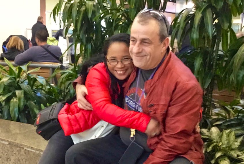 Ruby de Loyola spends a few final moments with husband Chris Abbass before embarking on the first leg of flight to the Philippines. The Sydney resident will return later this month with her two teenaged sons. De Loyola has not seen the boys for almost five years.