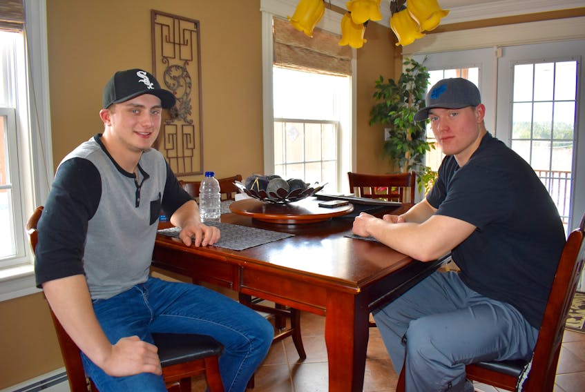 Garrett Whittle, left, and Matthew Williams are shown sitting at Whittle’s kitchen table Saturday morning. Whittle was given the M.G. Griffiths Award by the Lifesaving Society of Nova Scotia on March 29. The award was in recognition of Whittle saving Williams, his best friend for many years, from drowning in June 2016.