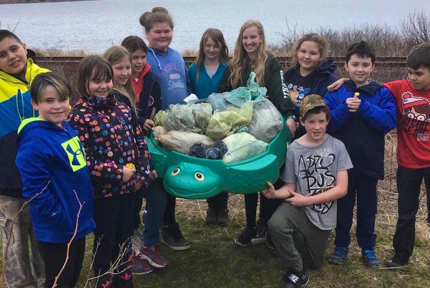 Students at Rankin School of the Narrows recently took part in a shoreline cleanup. From left are Jesse Young-Gagne, Rory MacNeil, Bhreagh MacKenzie, Kayla LeMoine, Emma MacNeil, Terin Lewis, Sarah Redden, Larissa LeMoine, Emma Cholak, Simon MacKenzie, Glenn Higgins and Alex Georgeson.
