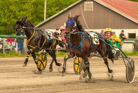 Accelerator and driver Greg Sparling, right, hold off a late challenge in the stretch from Private Paradise and driver Ryan Campbell, to take the Saturday afternoon feature on opening day at Northside Downs. Contributed/Tanya Romeo