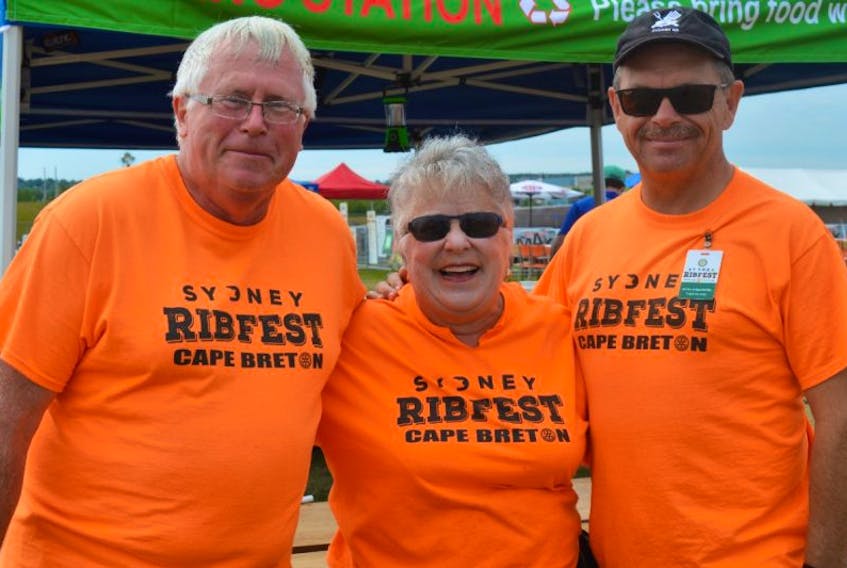 Peter Weaver, from left, logistic manager for Ribfest and Sunrise Rotary Club member, stands at one of the sorting stations with Sue Sunderland, a volunteer, and fellow Sunrise member Kevin Armstrong, who is the Ribfest co-chair.