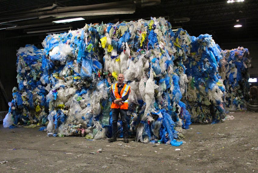 Jeff Stone, operations supervisor at Camdon Recycling in Edwardsville, stands in one of two rooms dedicated to storing film plastics. Since China stopped buying film plastics for recycling in January, the CBRM solid waste department has collected and stored about 200 tonnes of the product. Stone is 5’8” tall and the room is about 100 feet wide, with the stacks of film plastics, about 12 feet tall, going all the way to the back of the building.